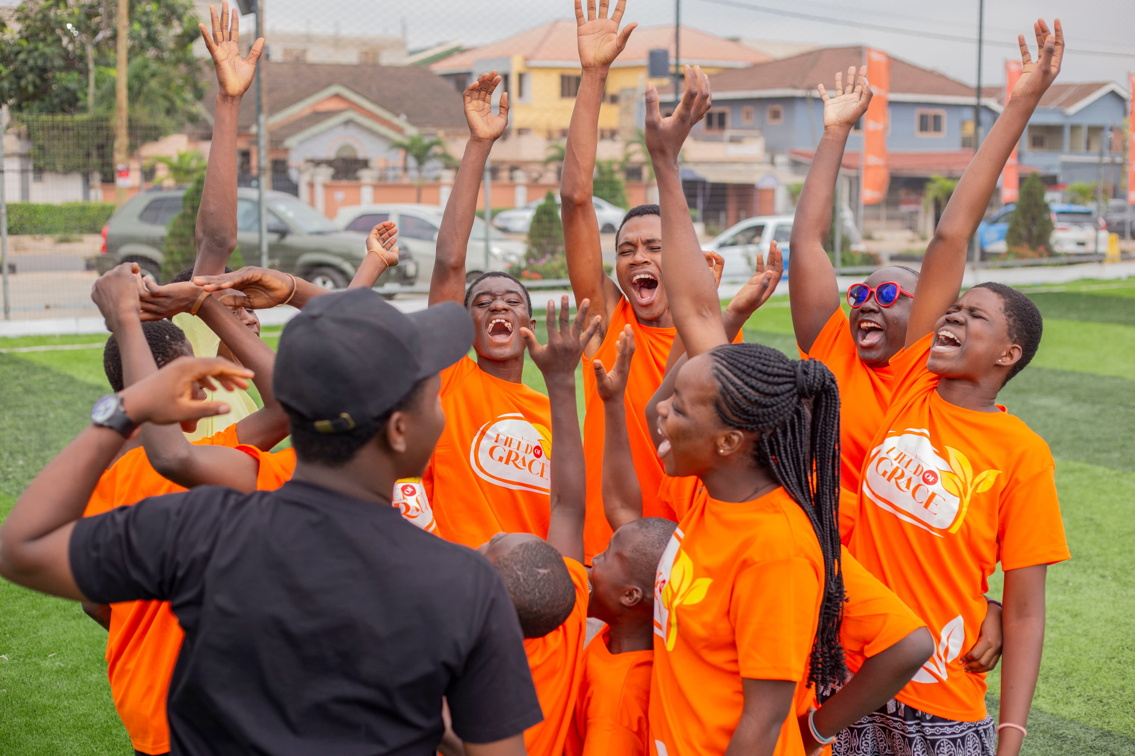Children and mentors celebrating at a Field of Grace day